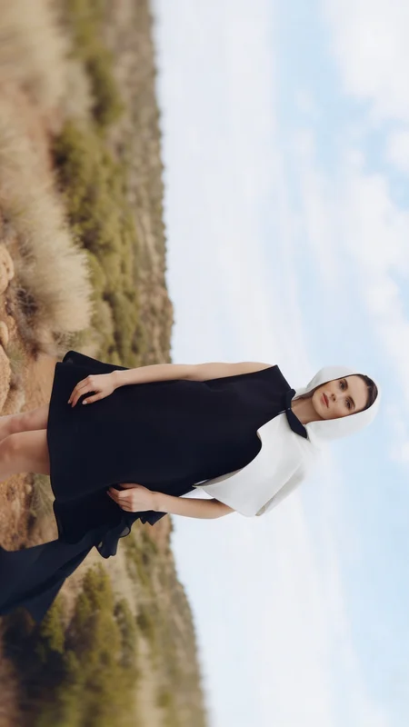 AI-generated black and white fashion editorial carousel showing a hooded woman in asymmetric desert composition with high-contrast silver-gelatin tonal quality across multiple frames variation 3